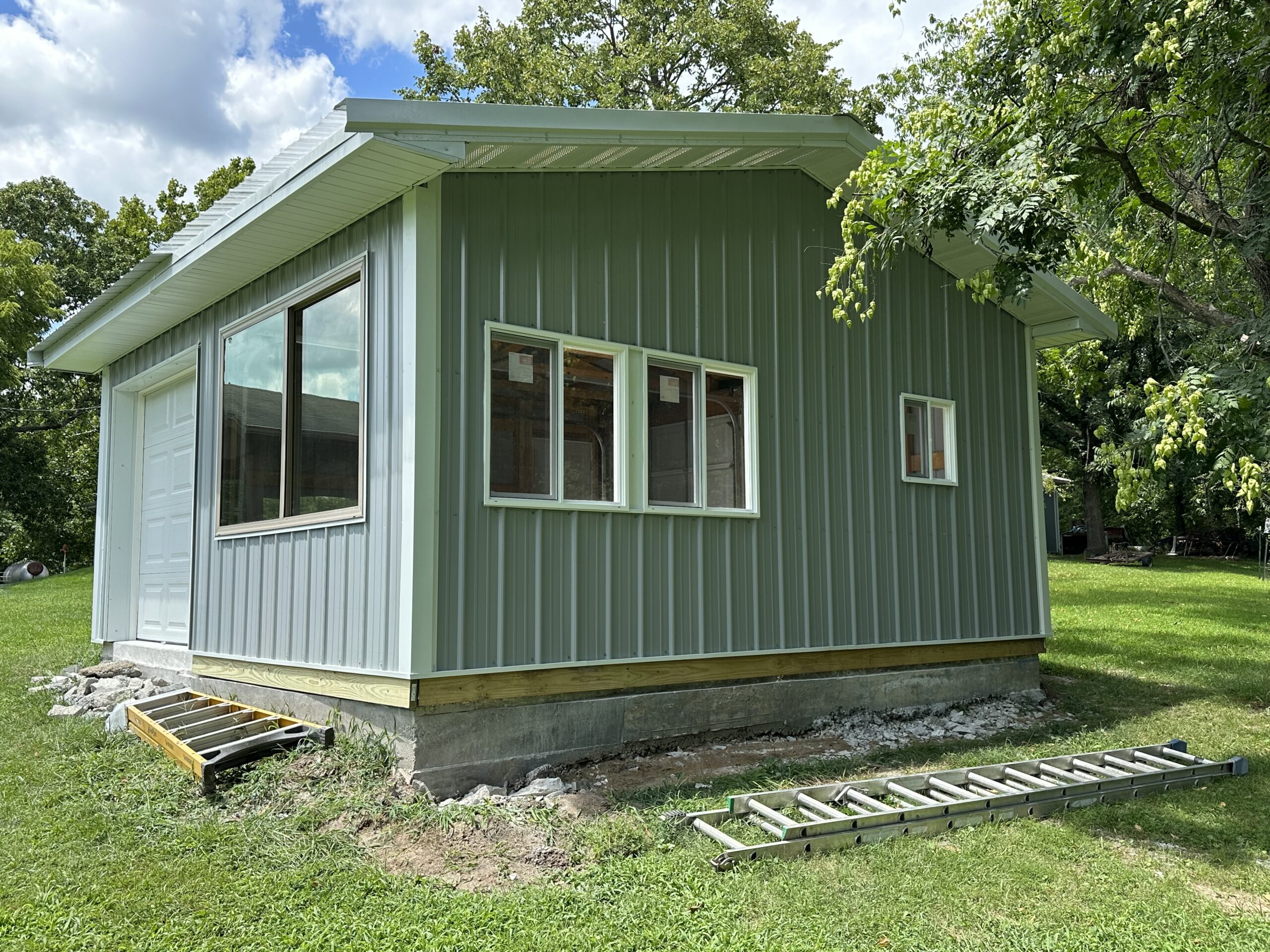 Small outbuilding structure with framing and concrete floor by Williams Construction