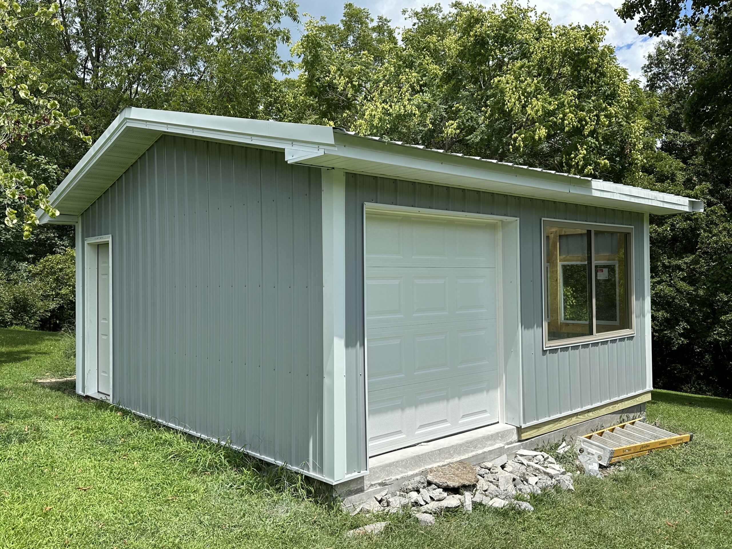 Small outbuilding structure with framing and concrete floor by Williams Construction