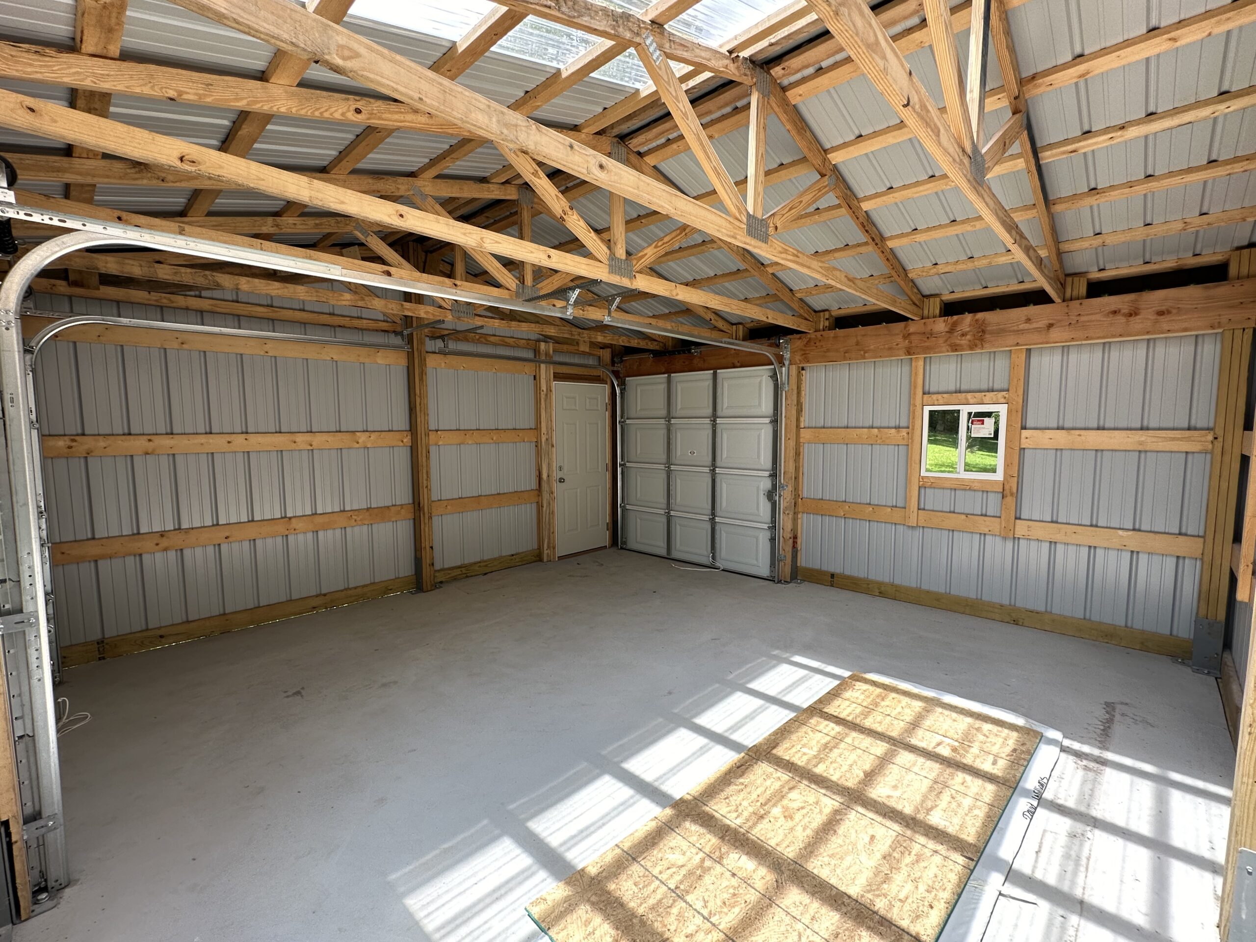 Small outbuilding structure with framing and concrete floor by Williams Construction