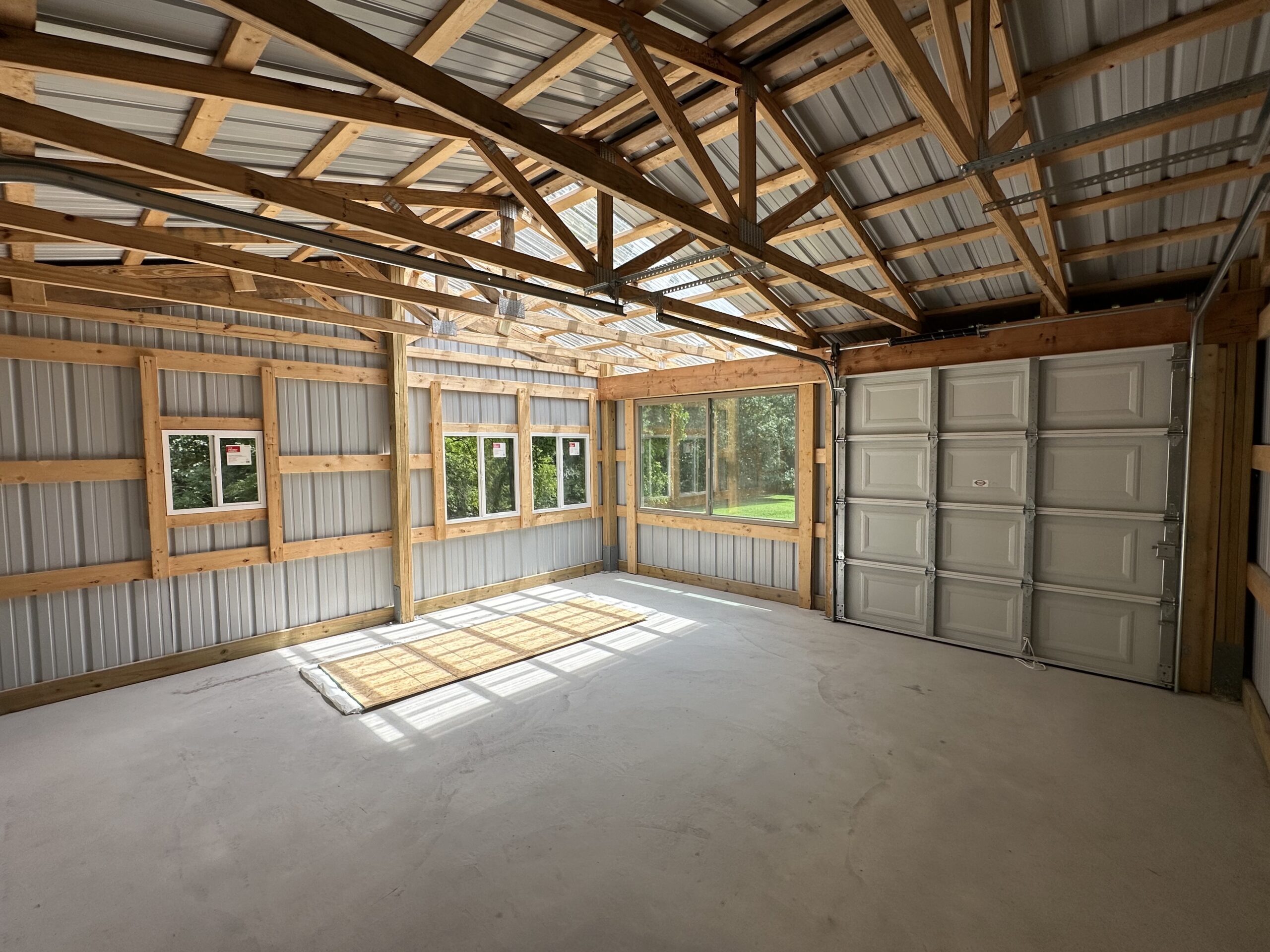 Small outbuilding structure with framing and concrete floor by Williams Construction